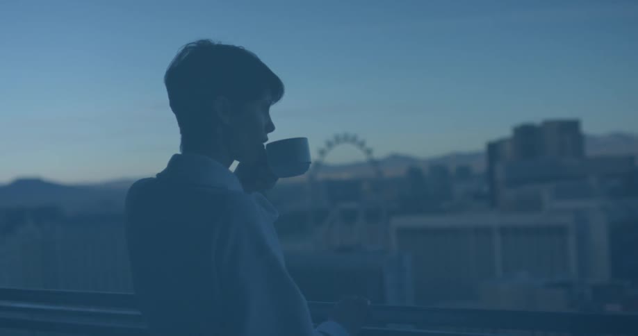A woman drinks coffee on a hotel balcony in las vegas