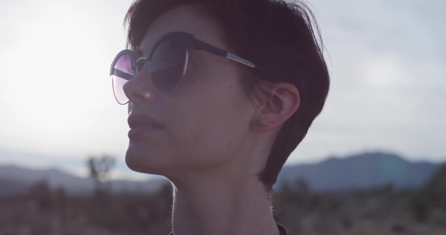 Woman standing in desert wilderness on sunny day