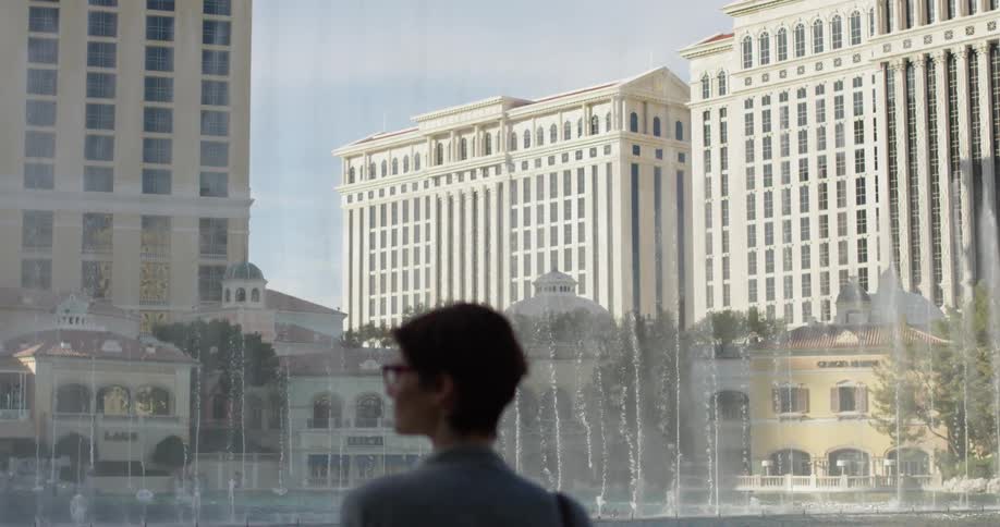 A woman watches fountains in las vegas