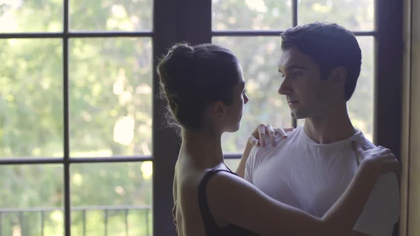 A male and female dancer rehearse in a studio