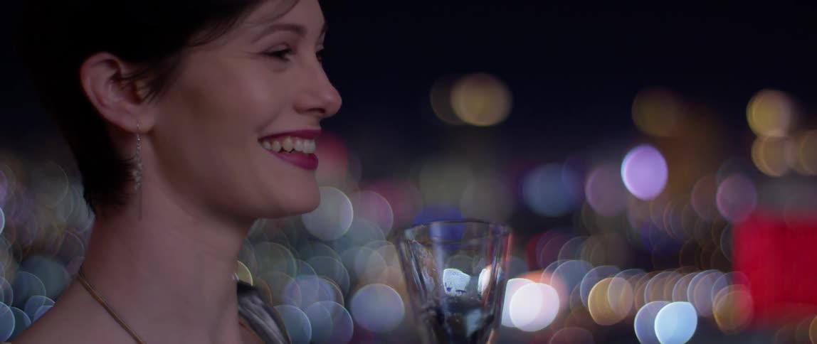 The woman is having a drink at night