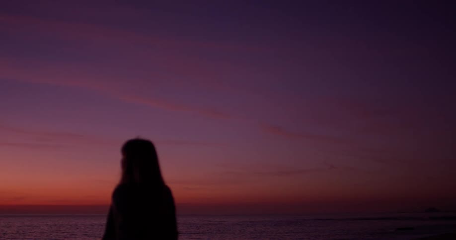 A person watches the sunset