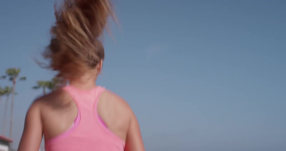 A woman jogs outside on a sunny day