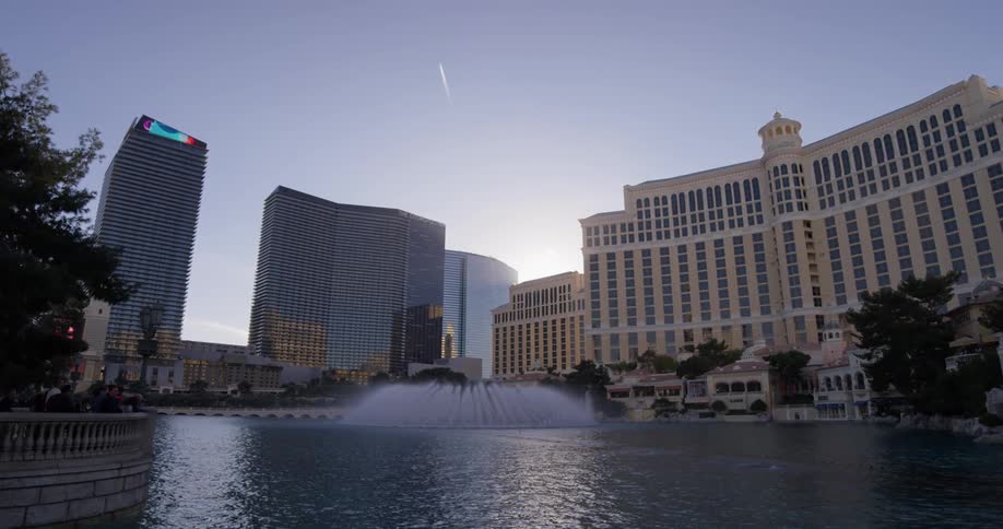 The fountain sprays water in front of the building