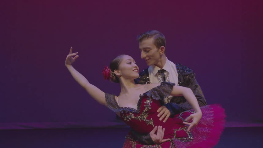 A male and female ballet dancer perform on stage