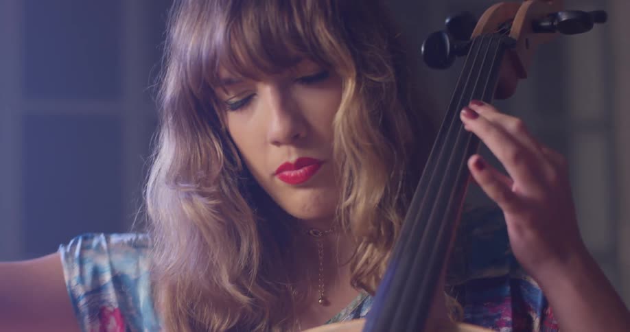 The woman is playing the double bass