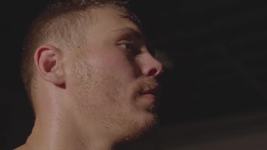A man looks to his side in the gym