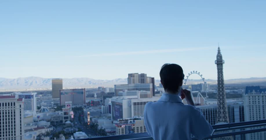 A woman walks out on her large balcony