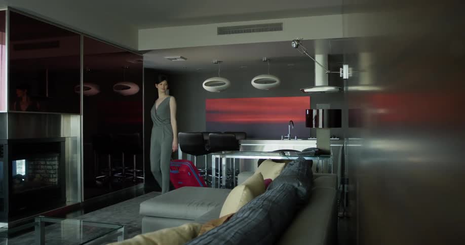 A woman walks into her living room
