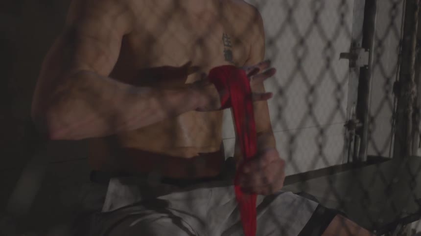 A man wraps athletic tape around his hand
