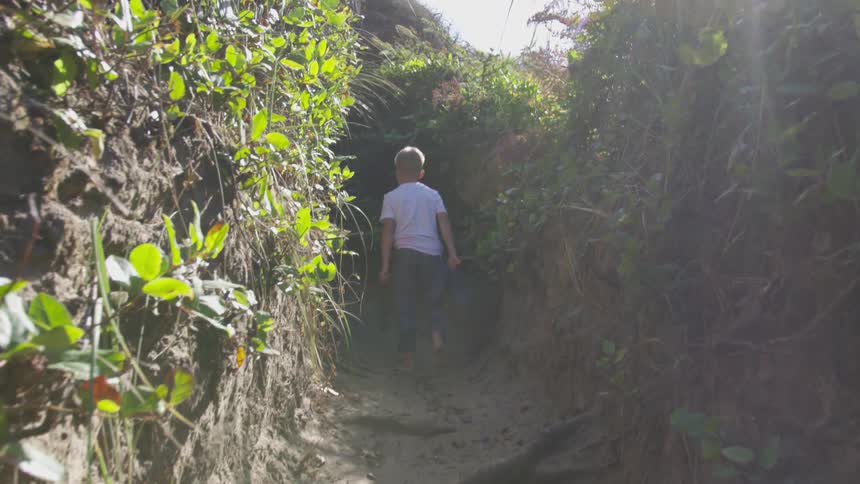 Brother And Sister Walking Barefoot On A Trail