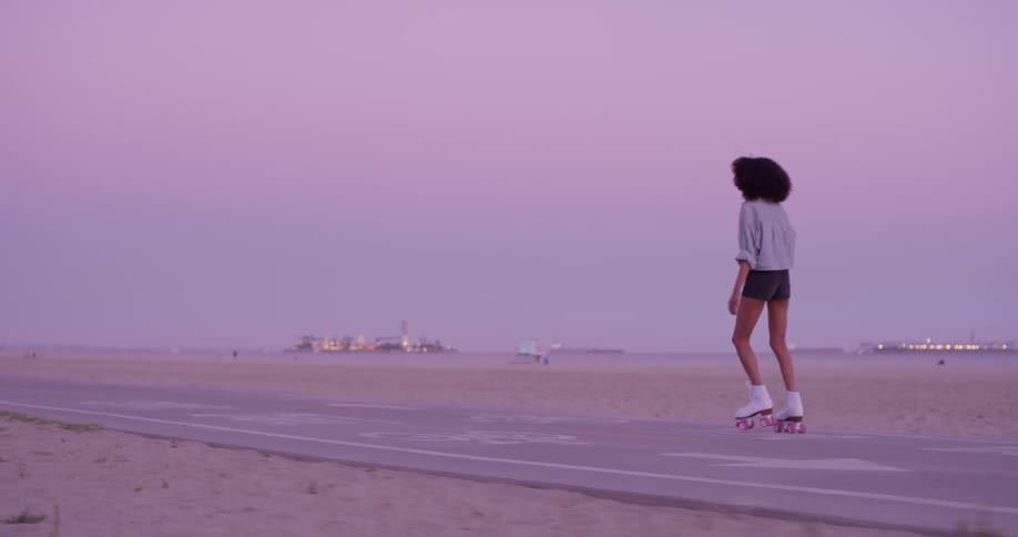 Woman Rollerblading Around Beach