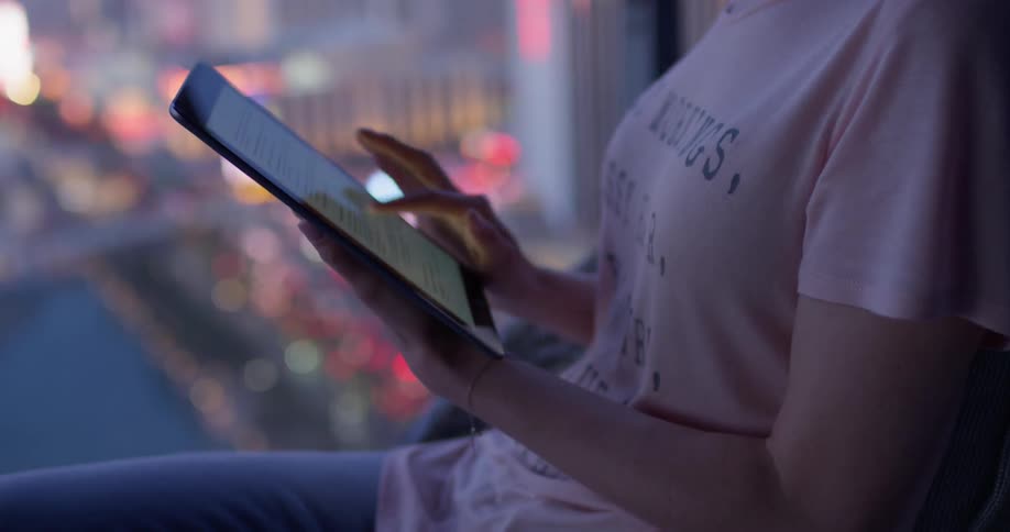 A woman flips through her tablet