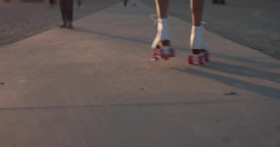 A person is rollerskating on the concrete path