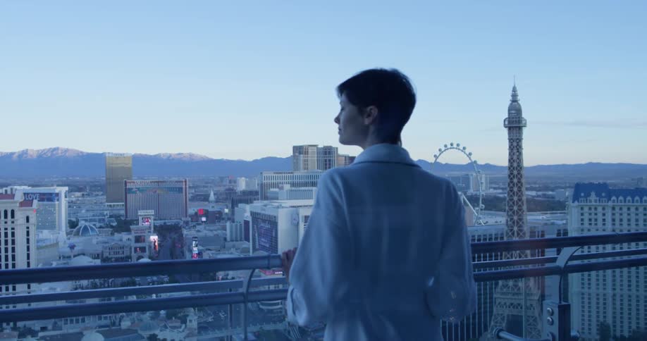A woman stands on a hotel balcony in las vegas