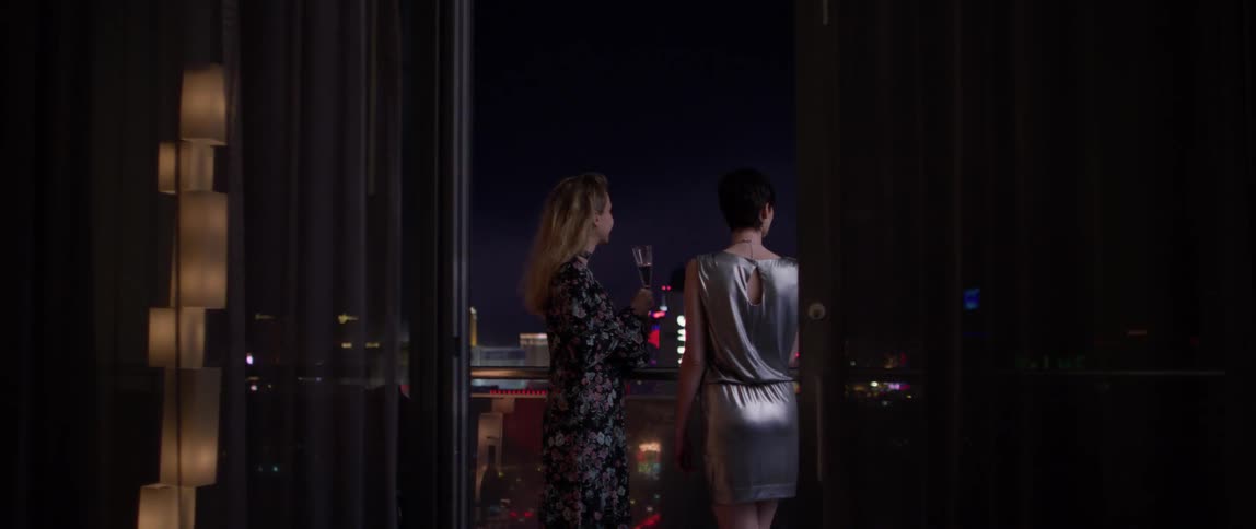 Two women drink champagne in las vegas at night