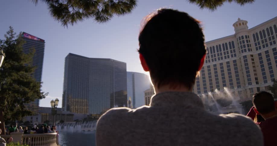 A woman photographs fountains in las vegas