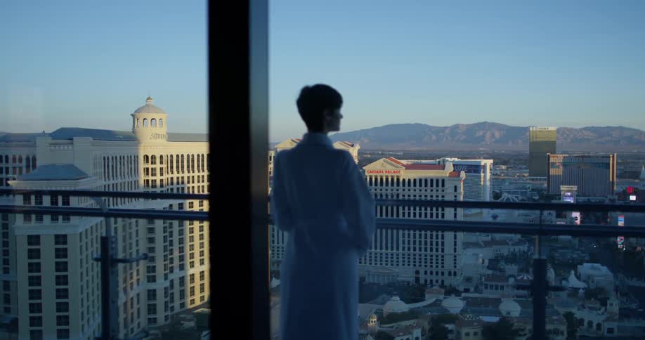 A woman stands on a hotel balcony in las vegas
