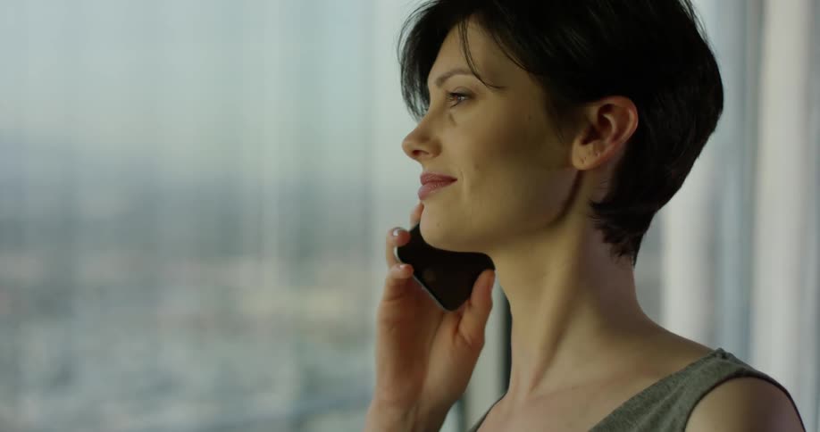 Woman smiles as she talks on the phone