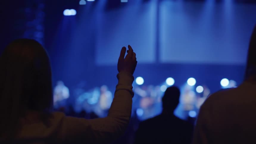 An audience watches a band perform on stage