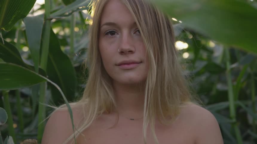 A woman is standing in the crop field