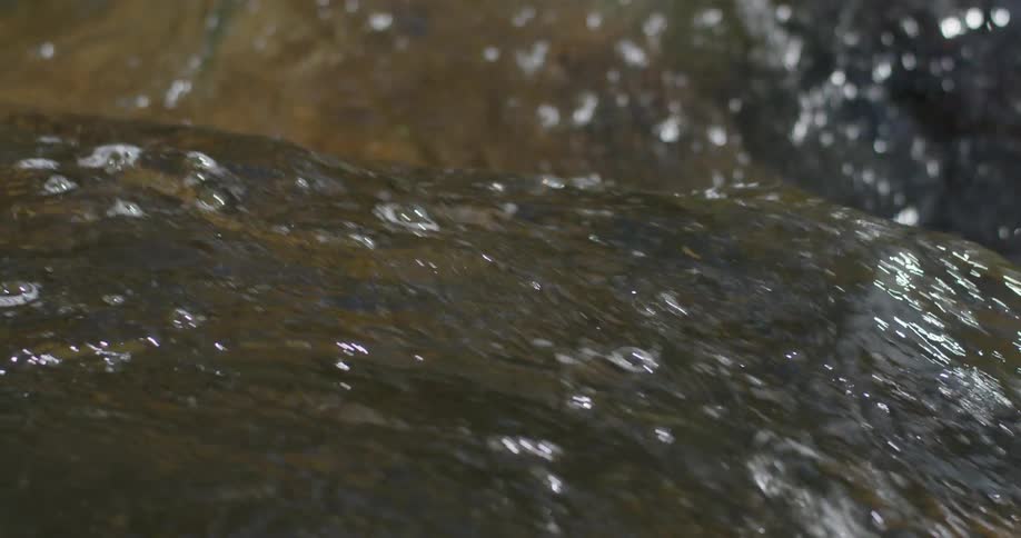 River water flows over a rock
