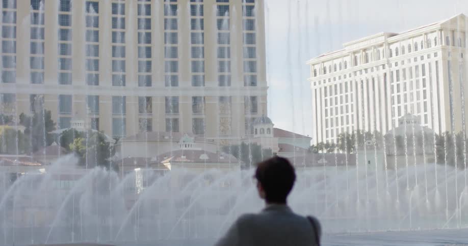 Woman watches the fountains shoot out the water