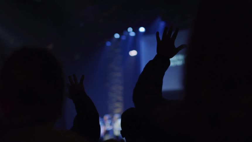 An audience watches a band perform on stage