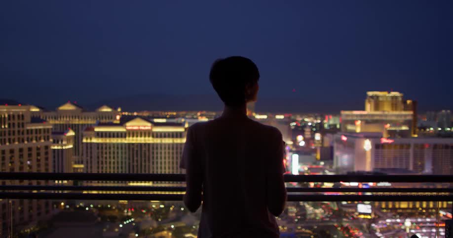 A woman stands on a hotel balcony in las vegas