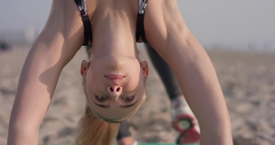 Woman Doing Yoga On The Beach