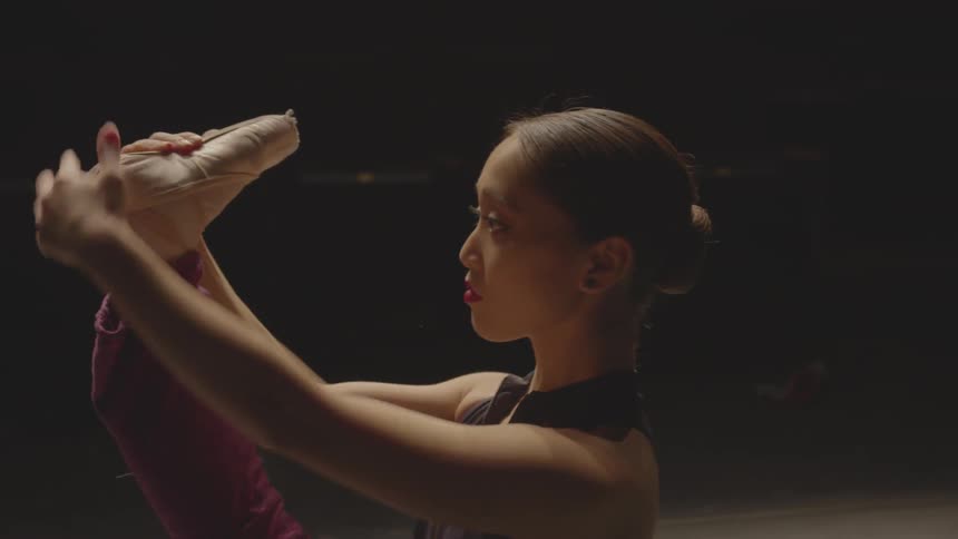 The woman is stretching her foot to her head