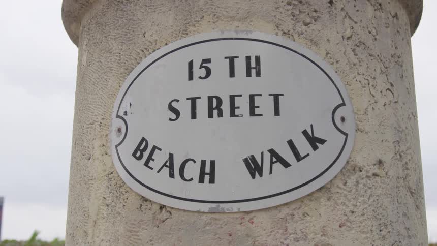 There is a sign marking the street on the stone