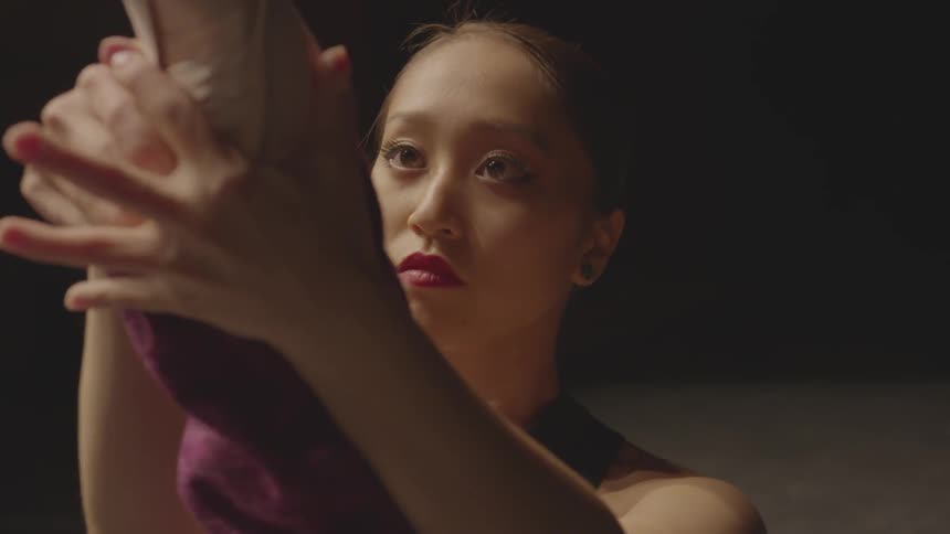 A ballerina stretches her feet