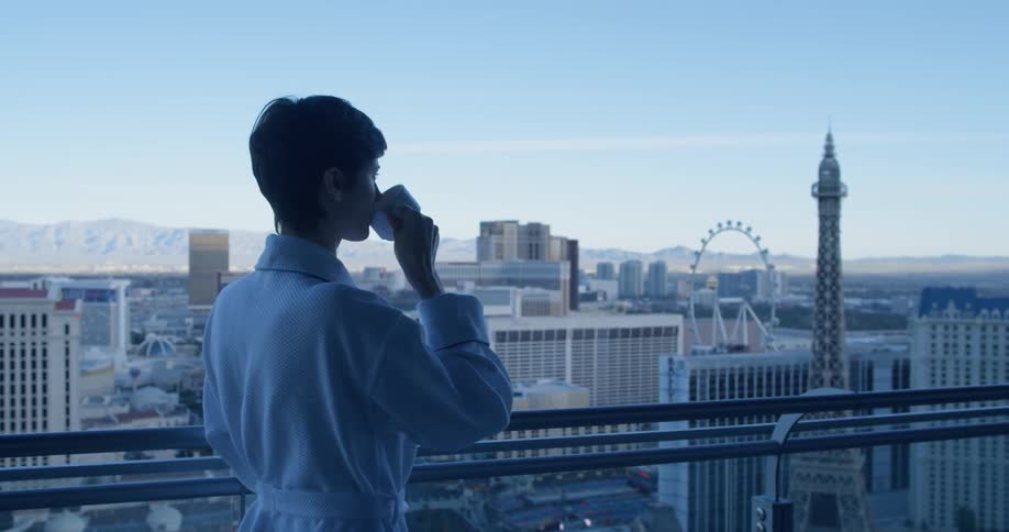 A woman drinks coffee on a hotel balcony in las vegas