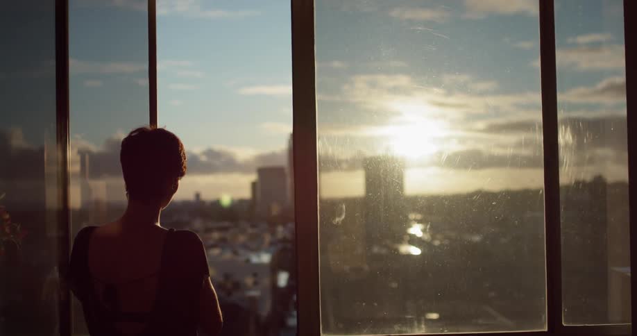 Woman slides open the window then turns and walks away