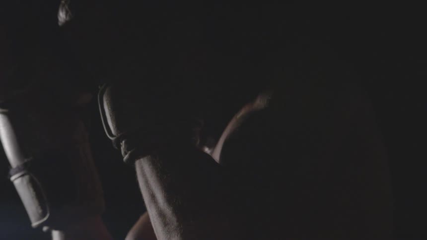 A boxer holds his gloves up to defend against punches