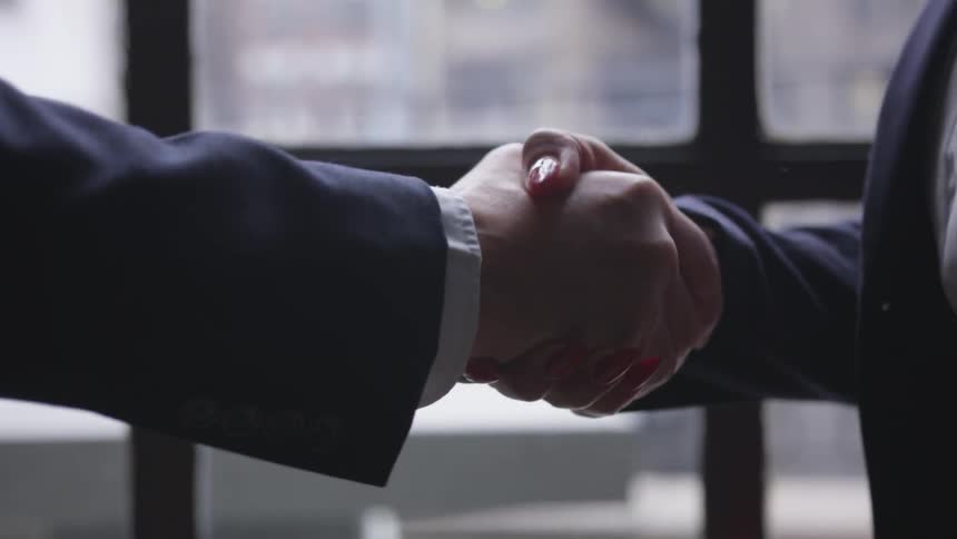 Two coworkers shake hands