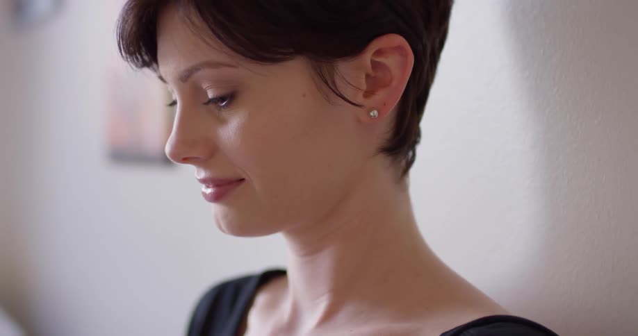 A woman smiles while concentrating on something