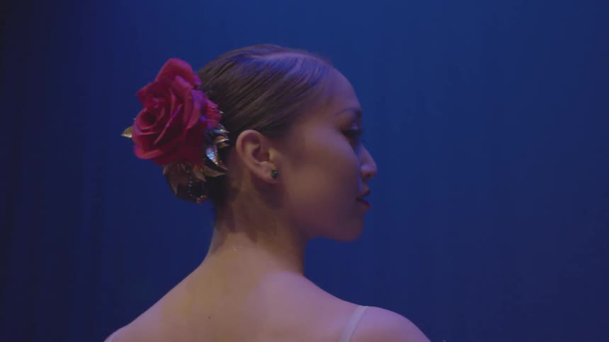 A woman smiles on the stage