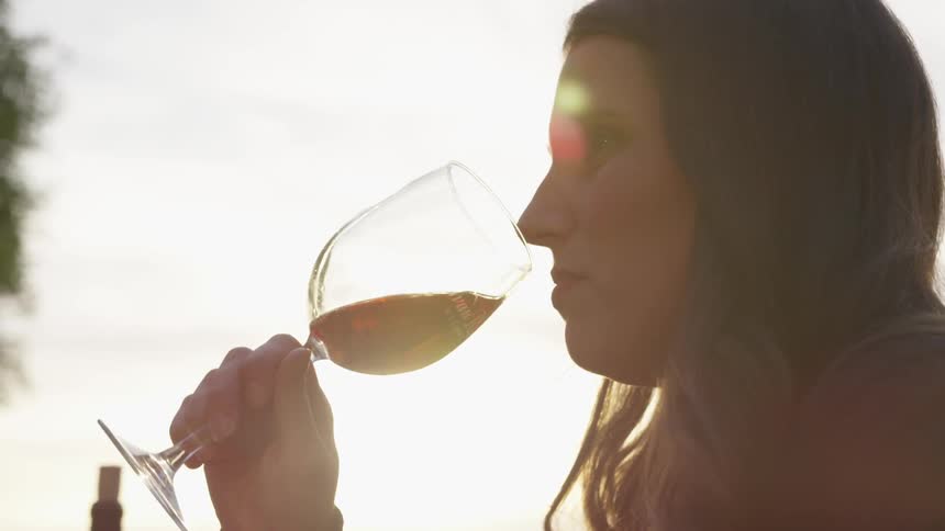 Woman sips liquid from a goblet