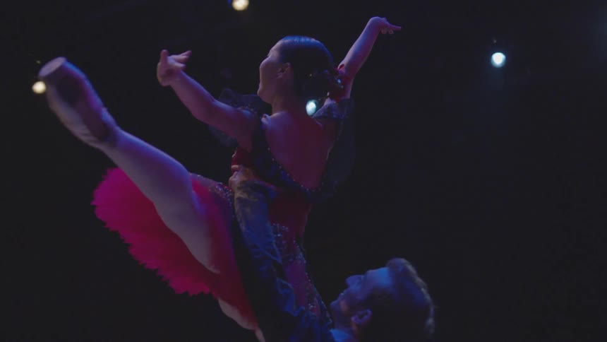 A male and female ballet dancer perform on stage