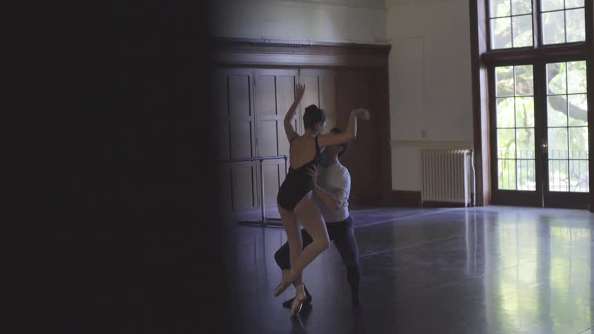 A male and female dancer rehearse in a studio