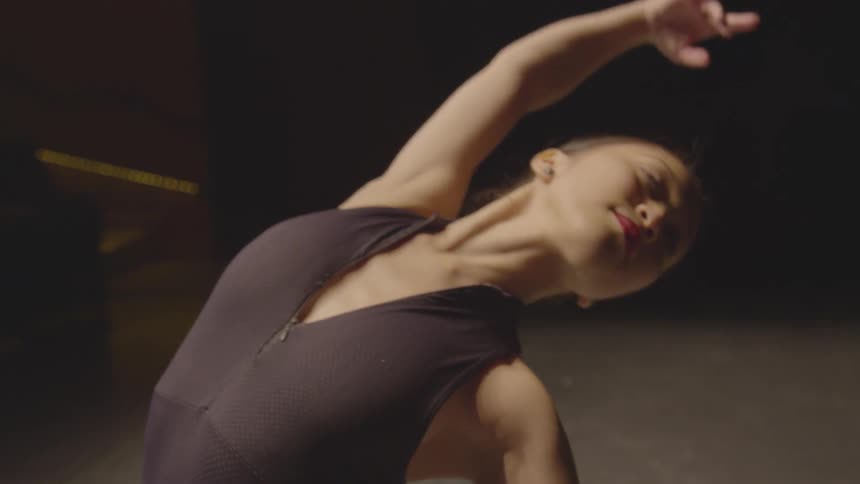 A ballerina rehearses on stage