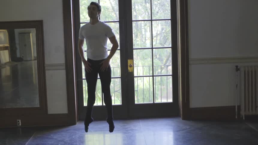 Man practices dancing in an empty room