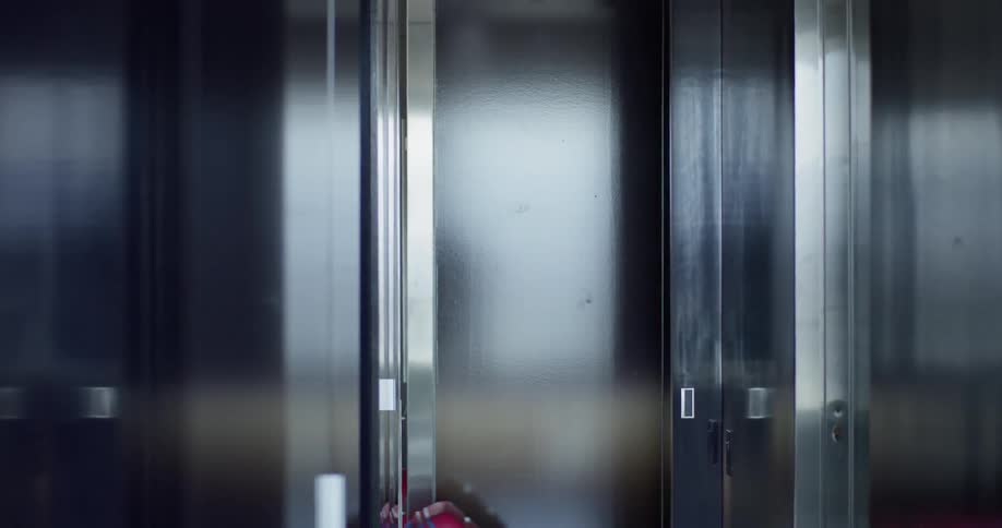 Woman pulls a suitcase down a hallway
