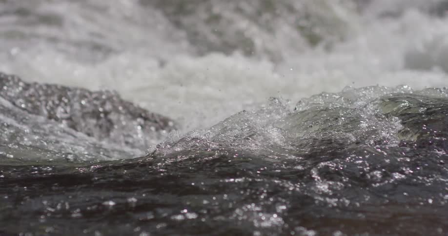 The water slowly moves over the rocks