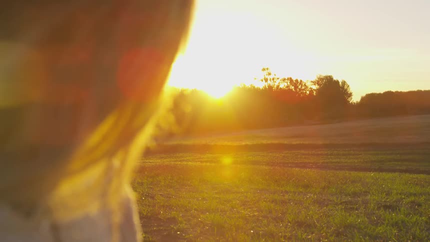 The sun is nearly sit as a woman watches