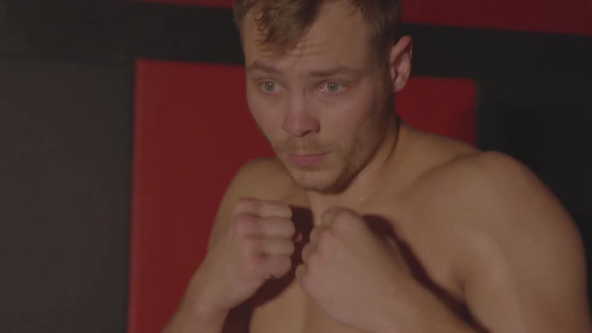 Man hops and has his fists in a boxer's stance