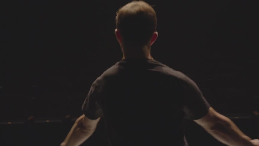 A man is dancing in the dark