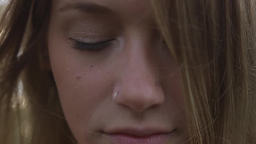A woman keeps her eyes shut